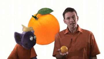 Jim holding an orange